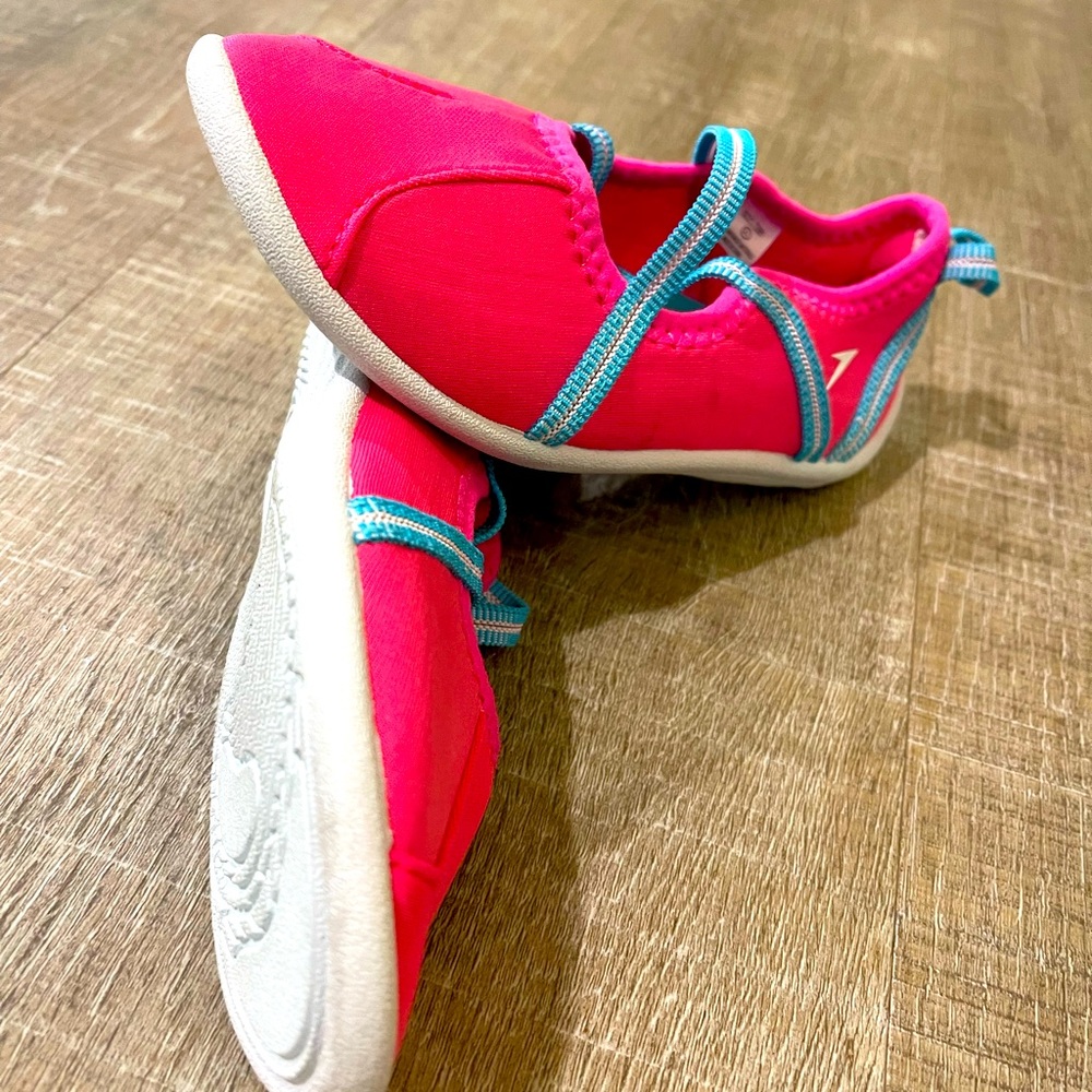 Bright pink with blue elastic straps swim shoes. New with no tags
